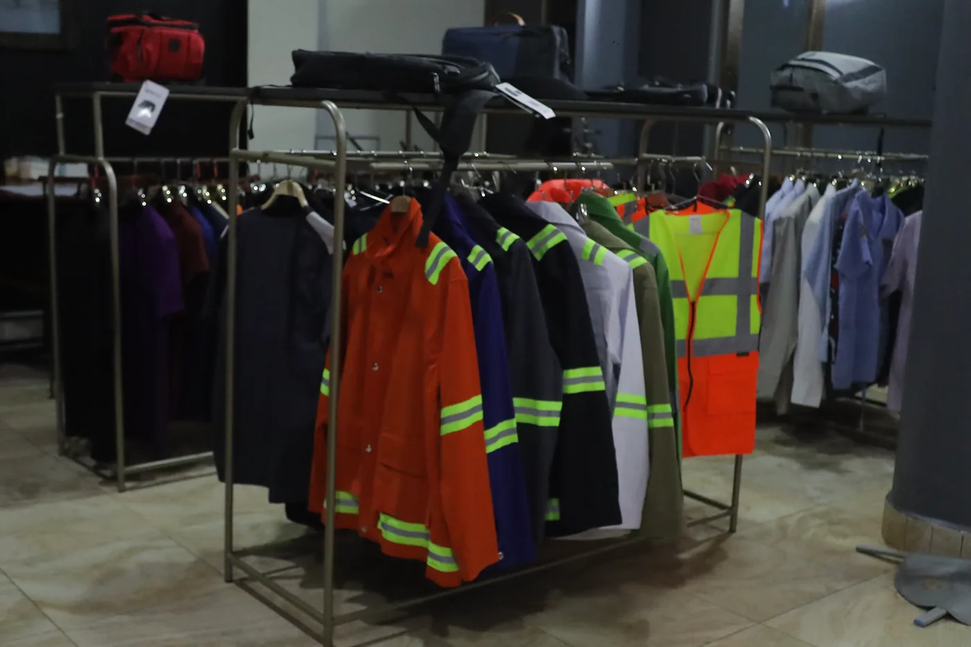 Workwear garments hanging together on a rack